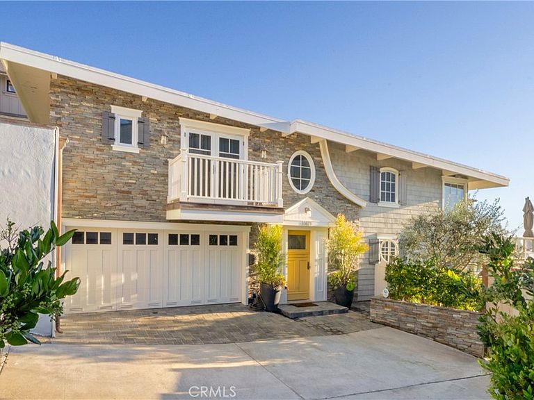 Stone-and-shingle front elevation with white trim and yellow Dutch door